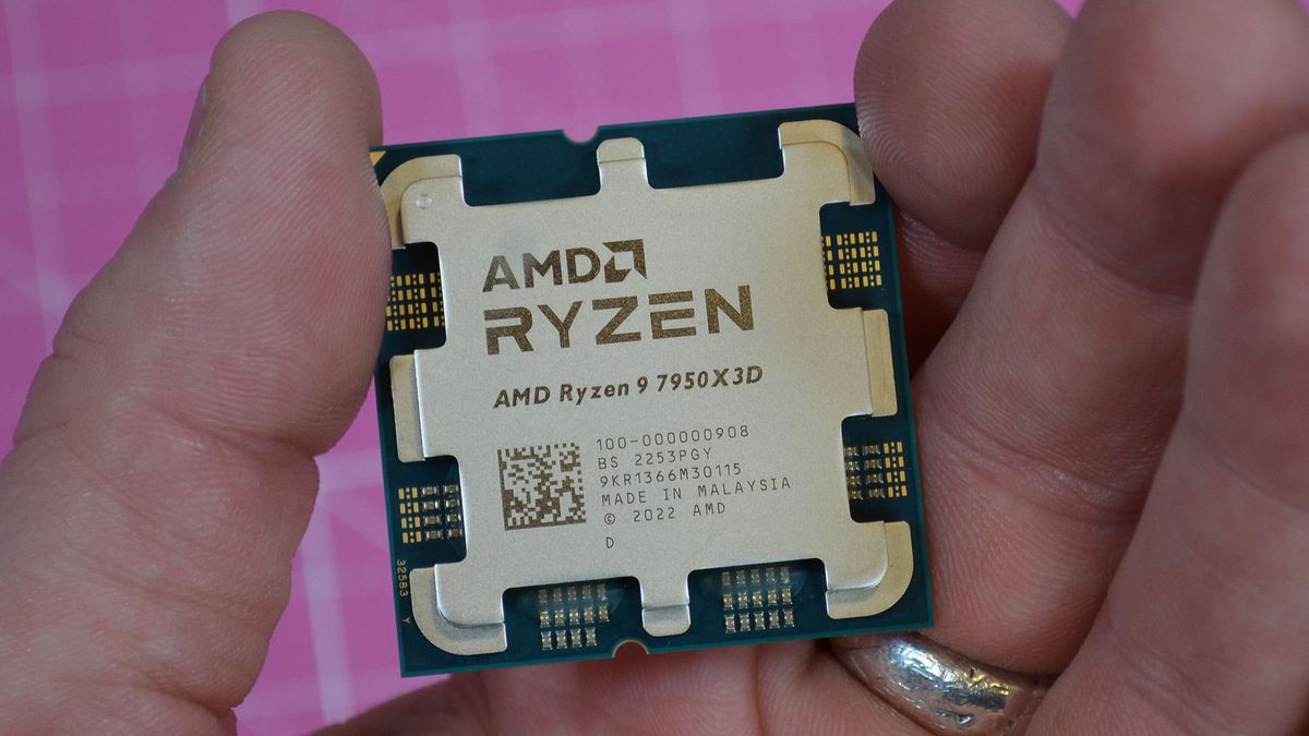 An AMD Ryzen 9 7950X3D held between a man